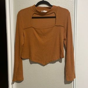 Orange long sleeve with open cut in front.